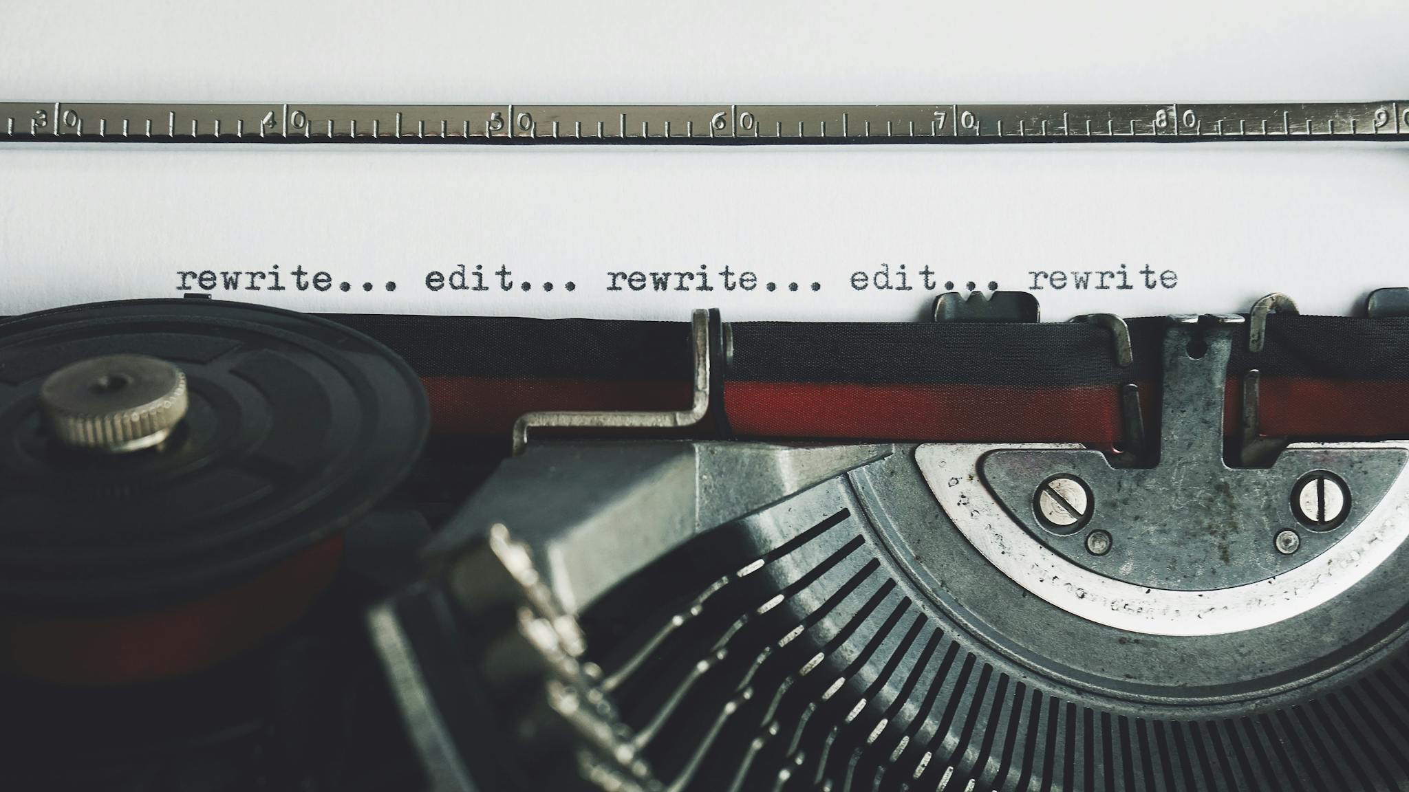 Home 1 Classic typewriter with text 'rewrite... edit...' on paper.